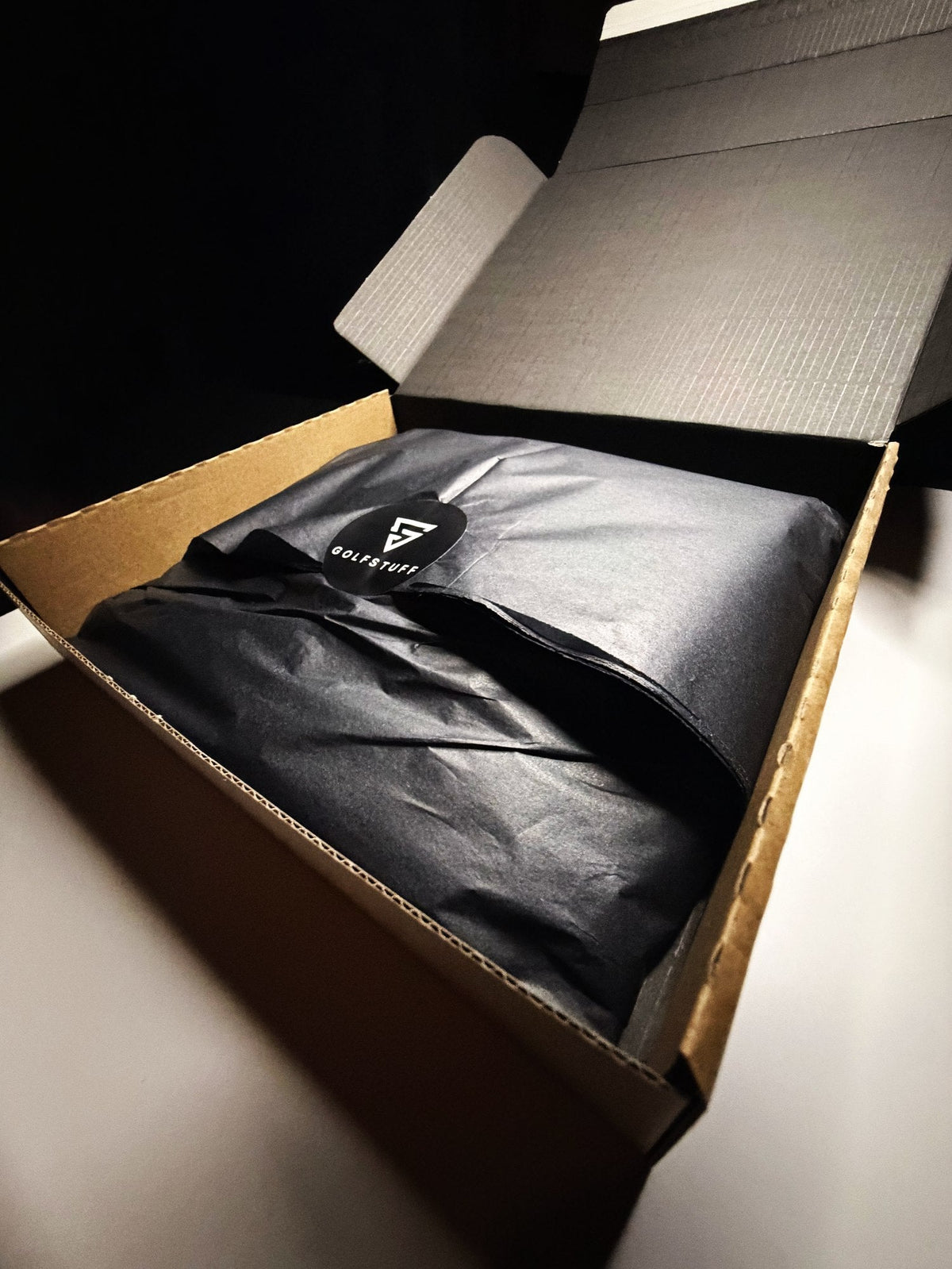 Golfstuff gift box being unwrapped